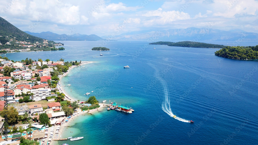 Fototapeta premium Aerial drone bird's eye view photo of iconic port of Nidri or Nydri a safe harbor for sail boats and famous for trips to Meganisi, Skorpios and other Ionian islands, Leflkada island, Ionian, Greece