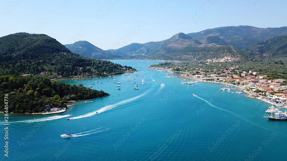 Naklejka premium Aerial drone bird's eye view photo of iconic port of Nidri or Nydri a safe harbor for sail boats and famous for trips to Meganisi, Skorpios and other Ionian islands, Leflkada island, Ionian, Greece