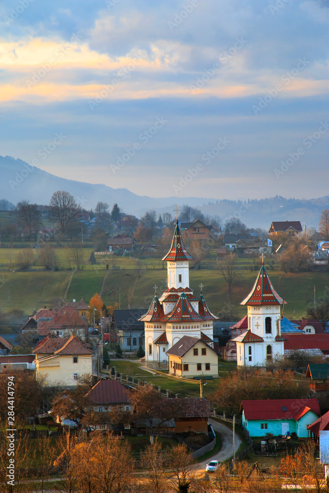Romania, Bucovina, Campulung Moldovenesc, Fall colors. Churches in valley.