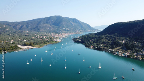 Aerial drone bird's eye view photo of iconic port of Nidri or Nydri a safe harbor for sail boats and famous for trips to Meganisi, Skorpios and other Ionian islands, Leflkada island, Ionian, Greece