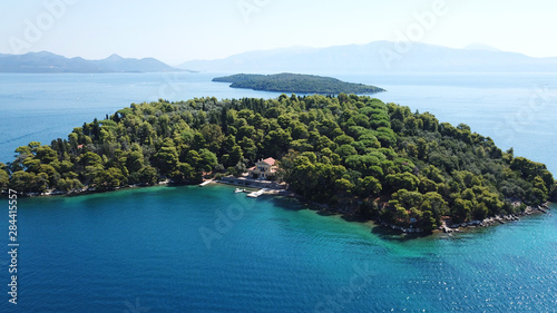 Aerial drone bird's eye view photo of iconic port of Nidri or Nydri a safe harbor for sail boats and famous for trips to Meganisi, Skorpios and other Ionian islands, Leflkada island, Ionian, Greece photo