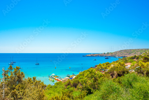 Fototapeta Naklejka Na Ścianę i Meble -   blue sea with clear water, mountains, yachts and the beach on the panorama of Konnos Bay Cyprus