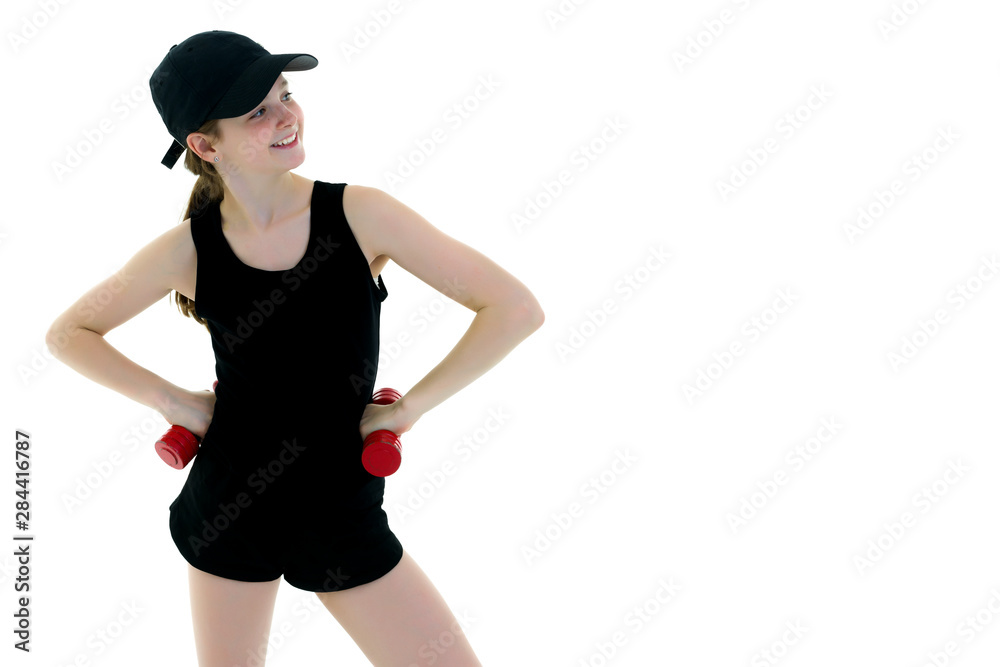 Teenage girl with dumbbells in hands Teenage girl with dumbbells in hands