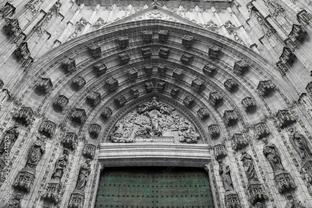 Spain, Andalusia, Seville. Gothic architecture of the cathedral door.