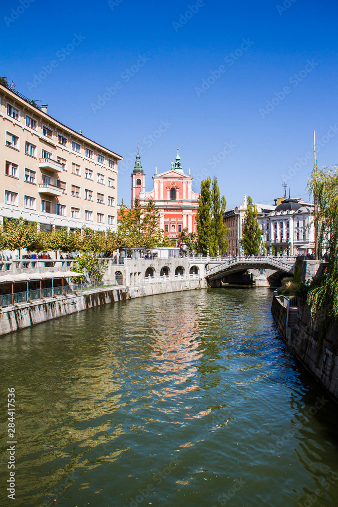 The Ljubljanica river, Ljubljana city, Slovenia in front of the Triple Bridge leading to Presernov Square and the Church of the Annunciation