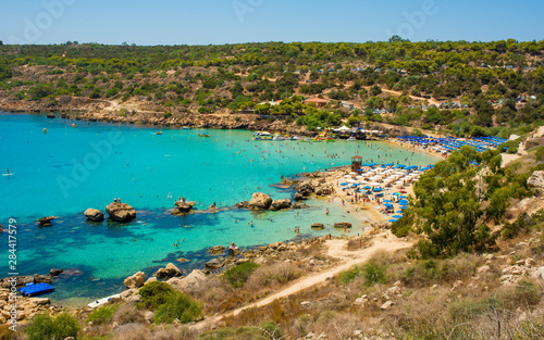 Fototapeta Naklejka Na Ścianę i Meble -   blue sea with clear water, mountains, yachts and the beach on the panorama of Konnos Bay Cyprus