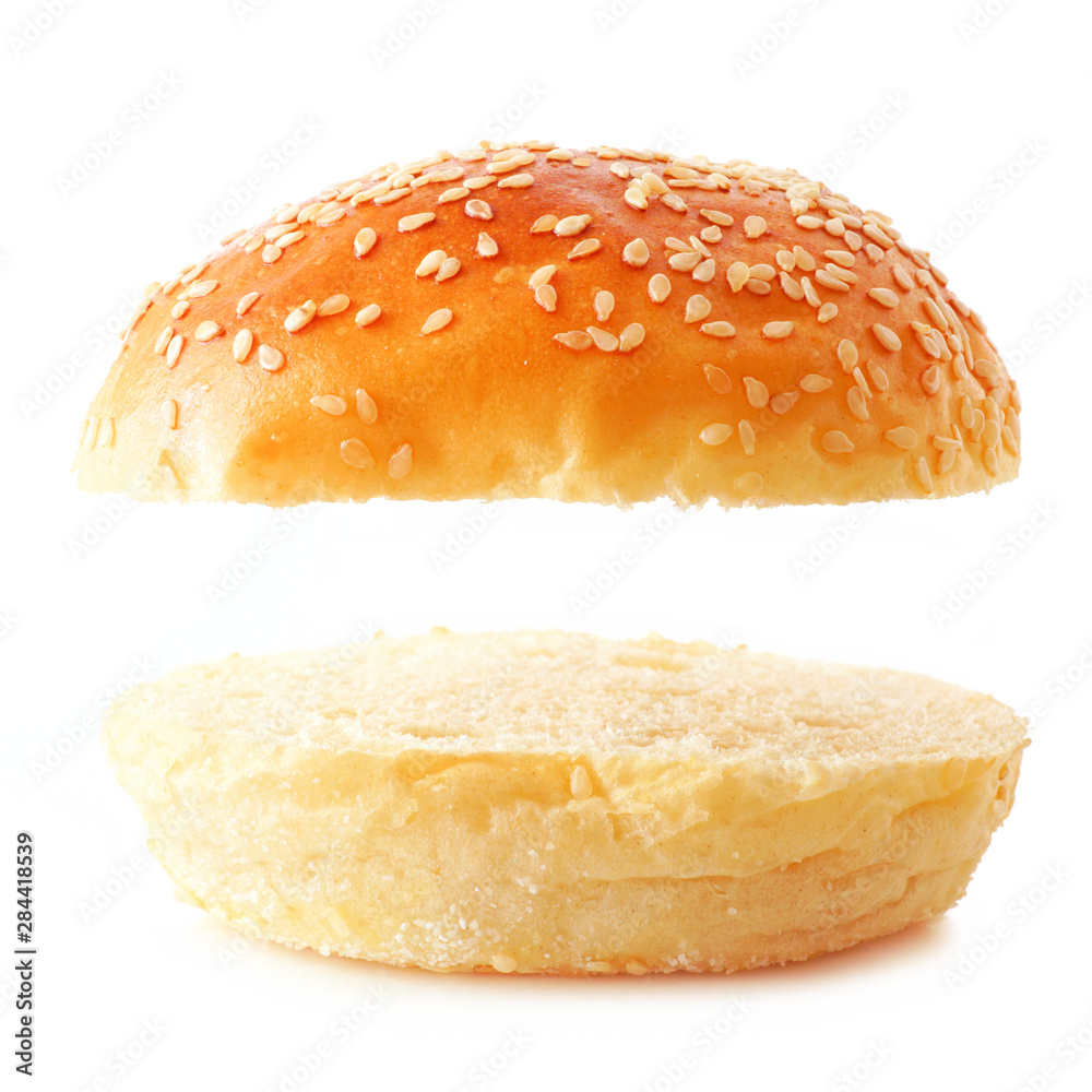 Open sesame seed hamburger bun on a white background. Top and bottom isolated with copy space.