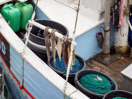 Bucket with lines and hooks for longline fishing. The harbor in town Ilulissat at the shore of Disko Bay in West Greenland. The icefjord nearby is listed as UNESCO World Heritage Site. photo