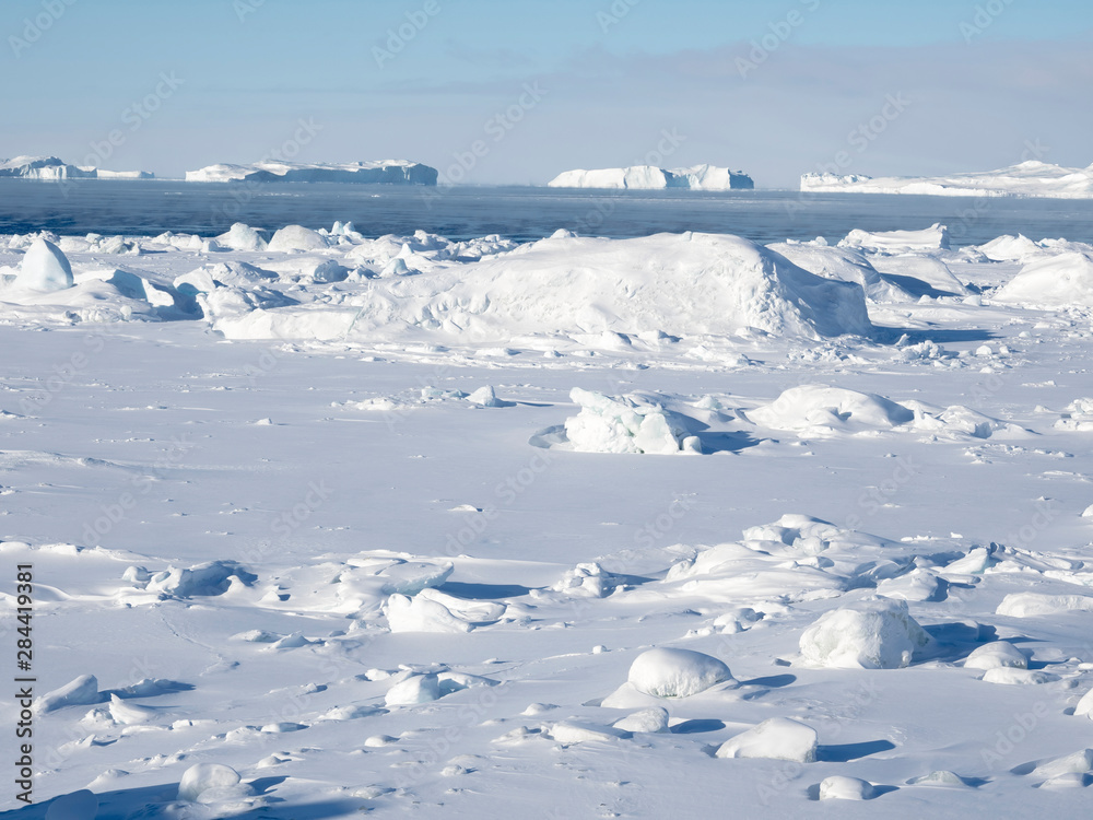 Frozen Disko Bay with icebergs at the Ilulissat Icefjord. The icefjord is listed as UNESCO World Heritage Site. Greenland, Denmark. Frozen Disko Bay with icebergs at the Ilulissat Icefjord. The icefjord is listed as UNESCO World Heritage Site. Greenland, Denmark.