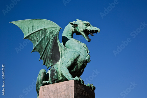 Dragon statue of sheet copper on the Dragon Bridge, Ljubljana, Slovenia, Art Nouveau style, Jurij Zaninovic the architect. photo