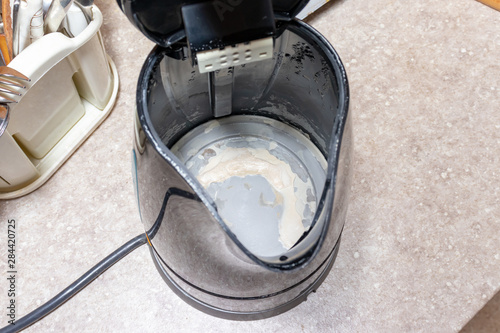 Limescale, lime scale in old kettle in kitchen. A white, chalky residue of calcium carbonate. Household appliances repair caused by hard water