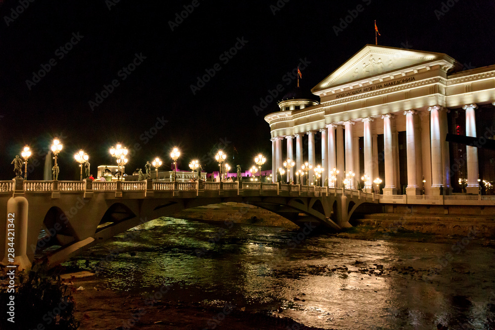 Obraz premium Central Balkan Peninsula, The Macedonia, Skopje, Ministry of Foreign Affairs and the Eye Bridge, a pedestrian bridge, Vardar River, between Stone Bridge and the Art Bridge, includes 28 sculptures .