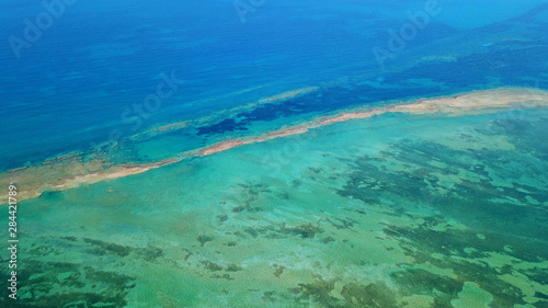Aerial drone bird's eye view photo of tropical caribbean paradise bay and lagoon with white sandy beach and turquoise clear sea