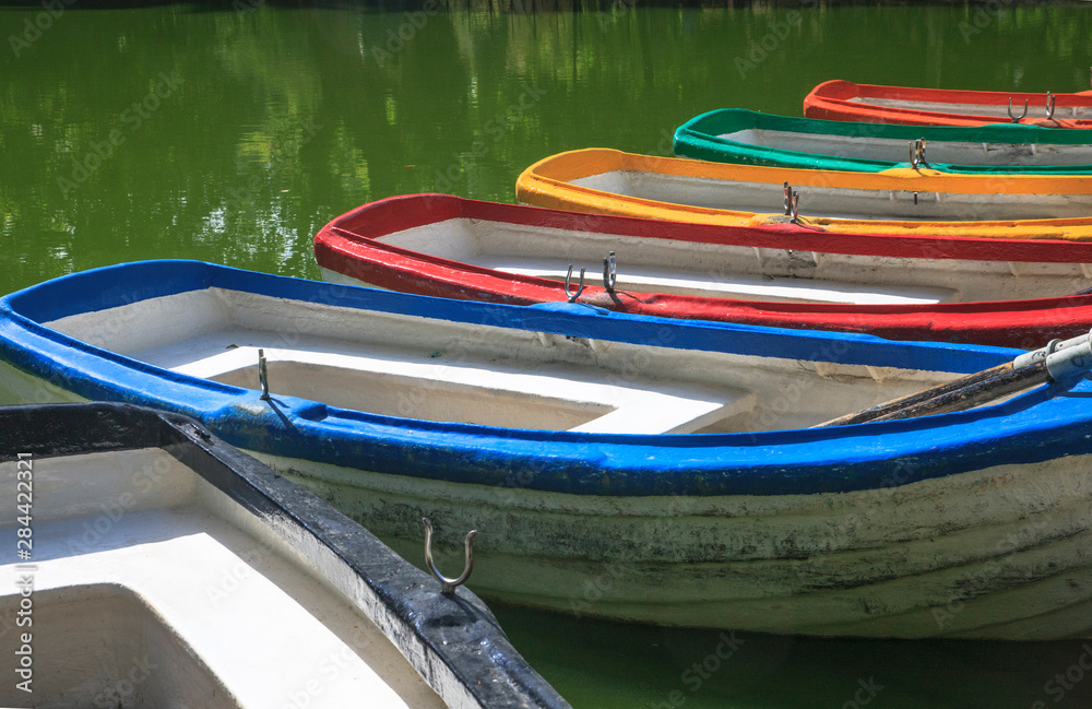 Sitting on a pond in the park, these rowboats were docked and available for rental