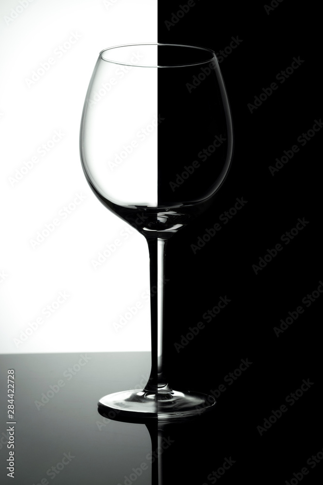 Empty wine glasses isolated on black and white  background. Wine list design menu with copy space.