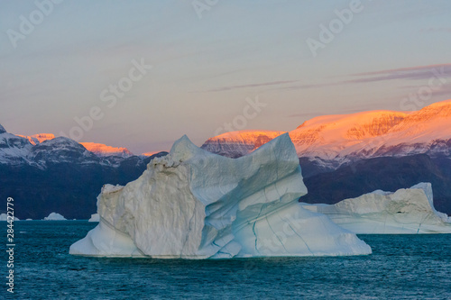 Greenland. Scoresby Sund. Gasefjord. Sunrise on the mountains with icebergs. photo