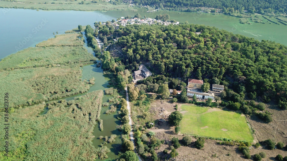 Aerial drone bird's eye panoramic photo of iconic city, castle and mosque of Ioanina surounded by famous lake and mountains of Pindus, Epirus, Greece