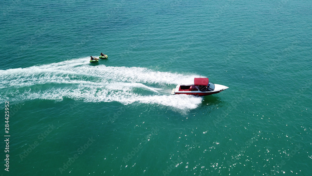 Fototapeta premium Aerial drone photo of extreme powerboat donut watersports crusing in high speed in tropical turquoise bay