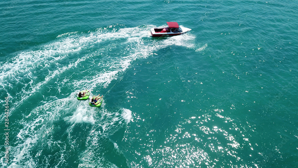 Obraz premium Aerial drone photo of extreme powerboat donut watersports crusing in high speed in tropical turquoise bay