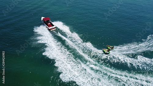 Aerial drone photo of extreme powerboat donut watersports crusing in high speed in tropical turquoise bay © aerial-drone