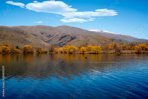 The beautiful reflection on the Lake lined by autumn colour