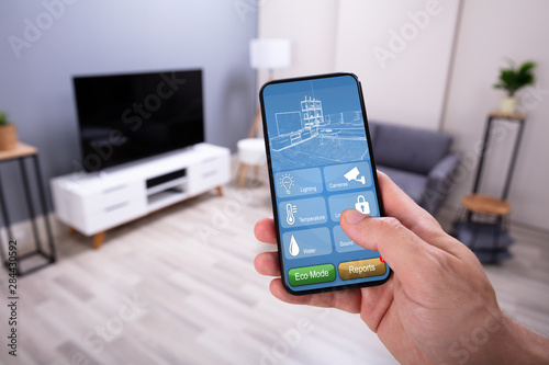 Person Using Smart Home System On Phone