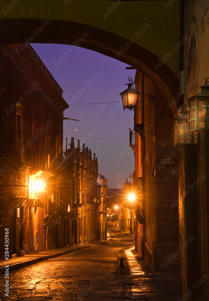 Obraz premium Mexico, San Miguel de Allende. Street with lanterns in pre-dawn. Credit as: Nancy Rotenberg / Jaynes Gallery / DanitaDelimont.com
