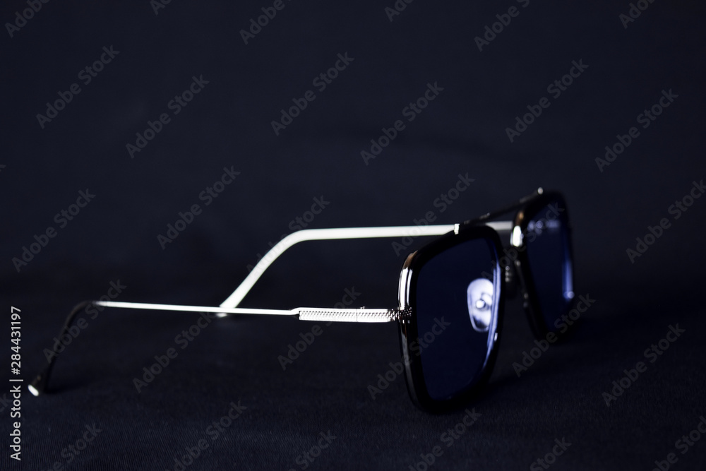 Close-up of retro sunglasses isolated on bokeh black background Close-up of retro sunglasses isolated on bokeh black background