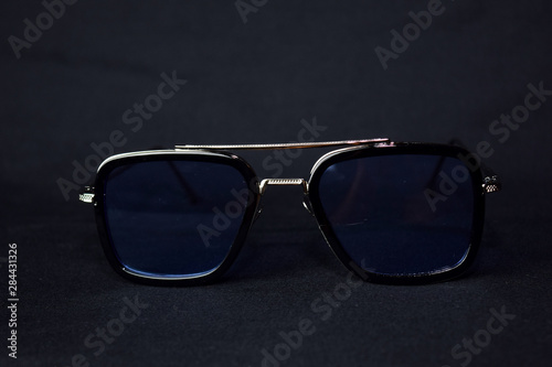 Close-up of retro sunglasses isolated on bokeh black background