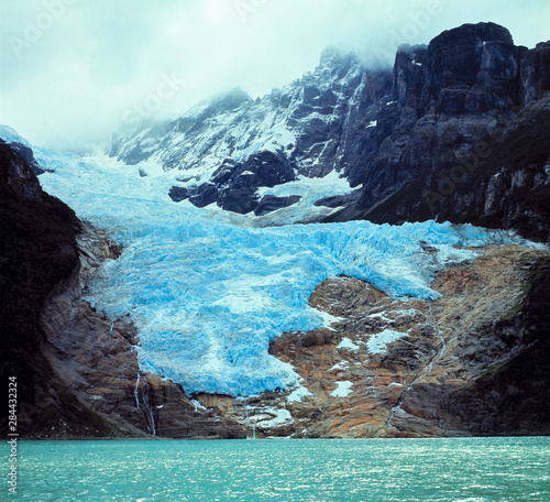 Chile, Ultima Esperanza Fjord. The blue ice of Balmaceda Glacier creeps toward Chile's Ultima Esperanza Fjord. photo