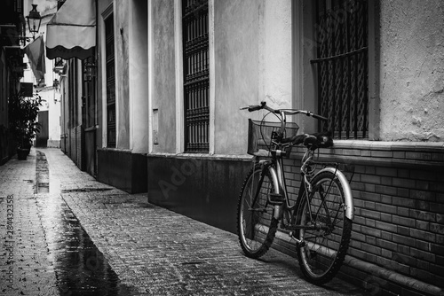 Bicycle Leaning Against a Wall In Alley