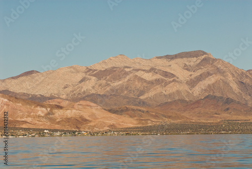 Mexico, Baja California, Bahia de los Angeles. Calm waters reflect mountains. Less development in Midriff Islands regions than Baja California South. Renown for whale sharks and fishing.
