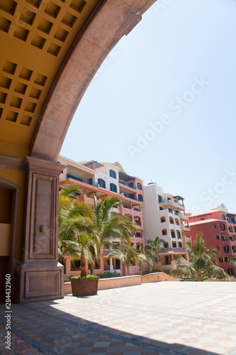 Cabo San Lucas, Baja California Sur, Mexico - Square patterns in the ceiling of an arched building. Other buildings can be seen in the background.