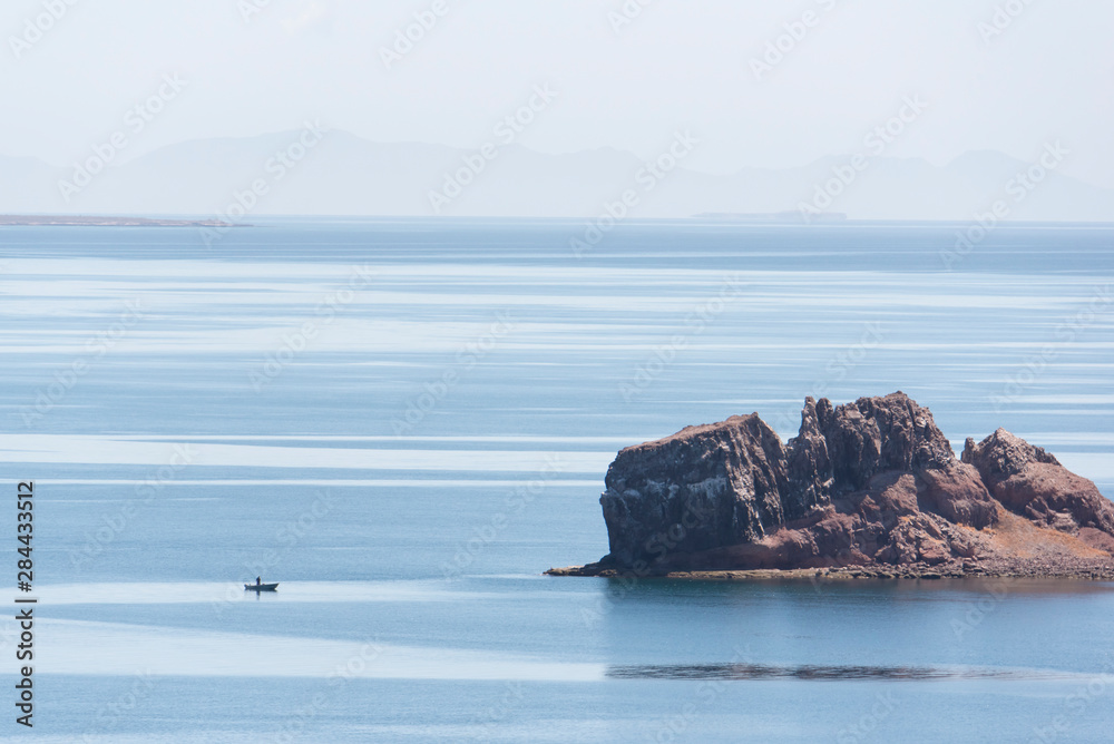 Mexico, Baja California Sur, Sea of Cortez. Calm waters, fisherman in panga