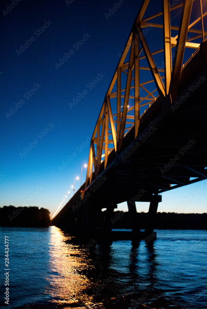Passing under a bridge on the Mississippi River at night Passing under a bridge on the Mississippi River at night