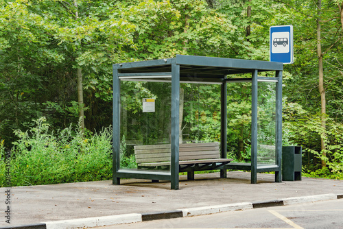 Empty bus stop in the summer forest.