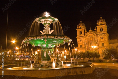 South America - Peru. Night shot of Plaza de Armas with fountain and La Compania in Cusco.