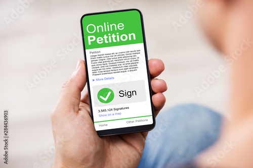 Man's Hand Holding Cell Phone With Blank Screen