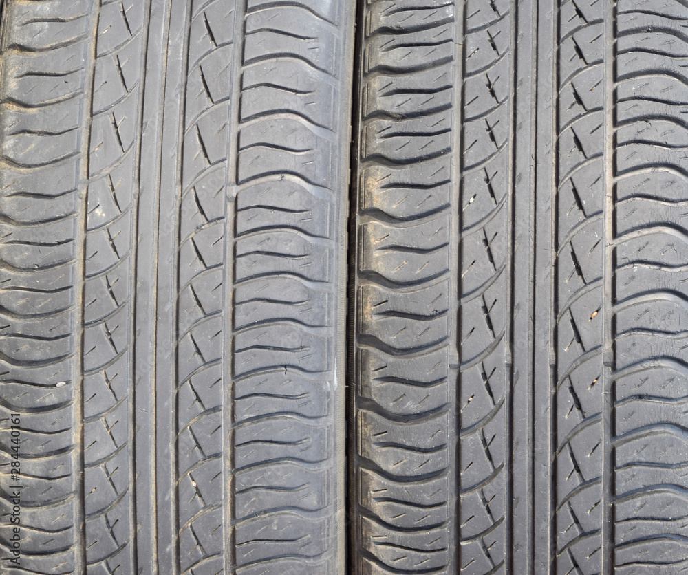 Fototapeta premium The background of the tread pattern of the car wheel. Rubber tir
