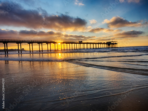 Scripps Institution of Oceanography Pier with sunset and bright clouds