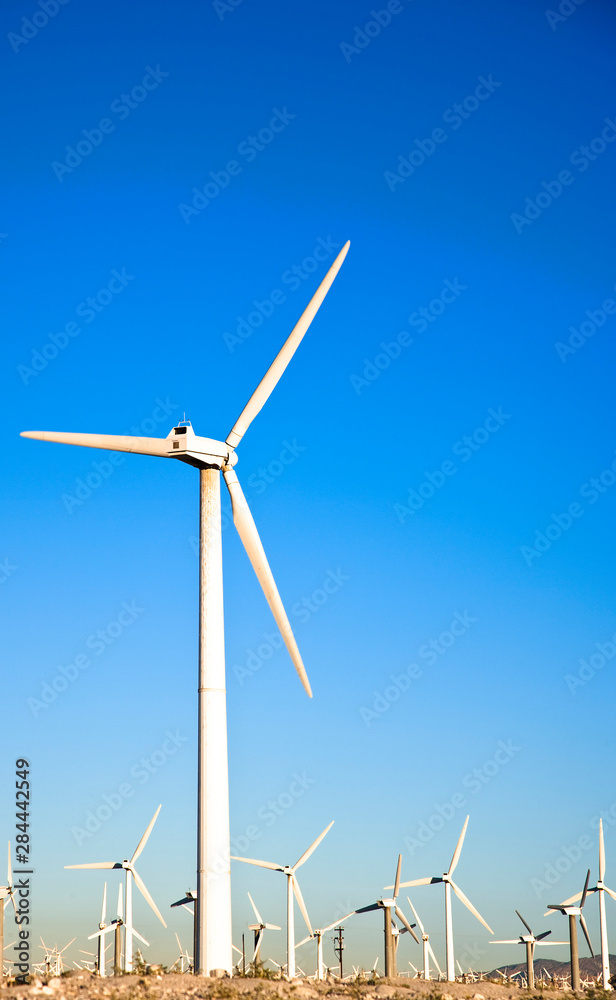 Palm Springs, CA, USA. View of wind turbines in the desert under a clear blue sky. Palm Springs, CA, USA. View of wind turbines in the desert under a clear blue sky.