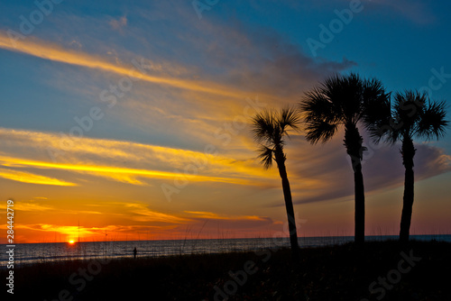 USA  Florida  Sarasota. Crescent Beach. Cloud streaked yellow-orange Siesta Key sunset