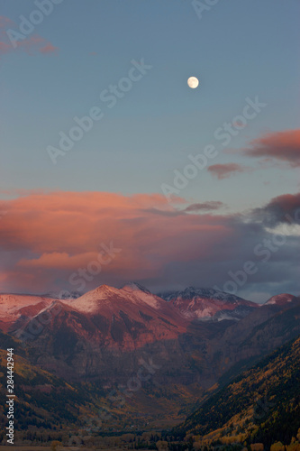USA, Colorado, San Juan Mountains, Telluride. A full moon rises above the mountains at sunset 