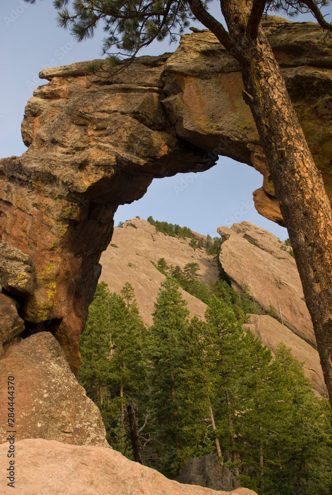 USA, CO, Boulder. Chatauqua trail out of Boulder to Flatirons and Royal Arch. 25' tall sandstone arch. Frames Flatiron in morning light