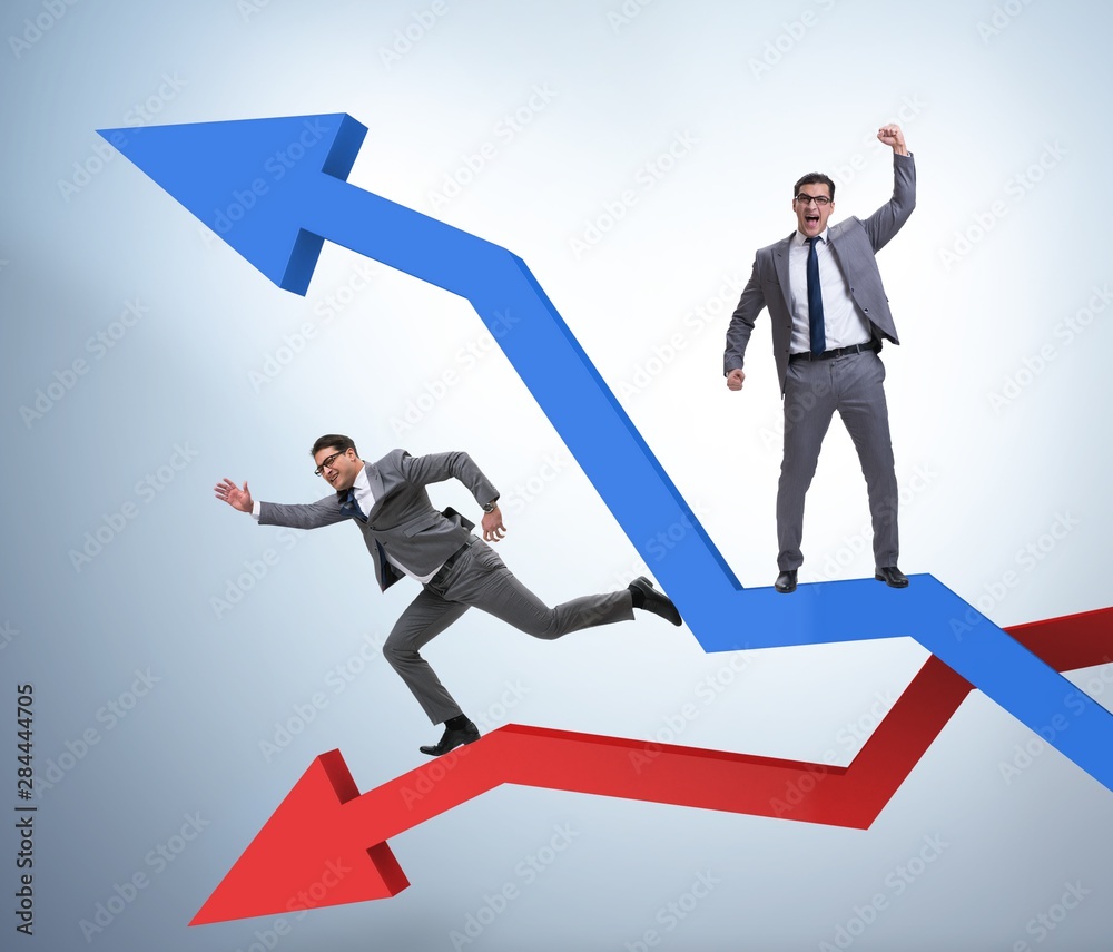 Businessman with charts of growth and decline Businessman with charts of growth and decline