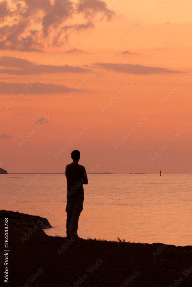 USA, Florida, Everglades National Park. Man overlooks Florida Bay at sunrise.