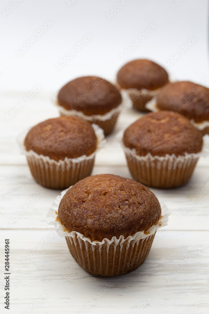 Homemade delicious chocolate muffins on wooden light table. Cupcake close-up. Homemade pastry rustic style. Minimalism. Homemade delicious chocolate muffins on wooden light table. Cupcake close-up. Homemade pastry rustic style. Minimalism.