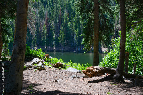 Camping spot along a rocky mountain alpine lake