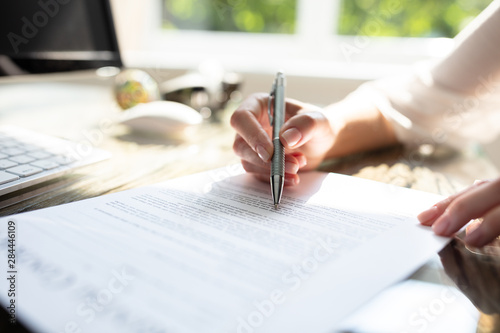 Businesswoman's Hand Signing Contract With Pen