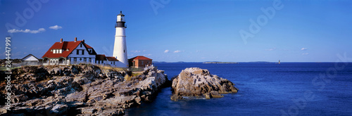 USA, Maine, Portland Head Light. The white-washed Portland Head Lighthouse, in Maine, is contrasted by the deep blue of sea and sky, Maine. photo